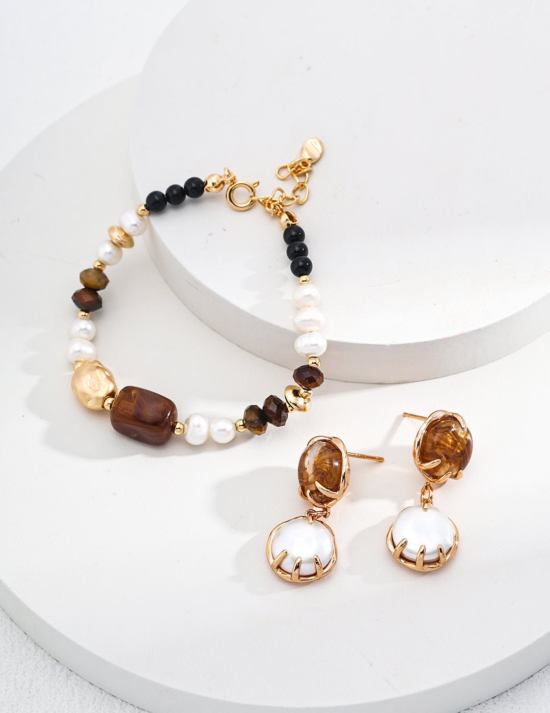 Bracelet with pearl, tiger eye, and agate beads with amber and mother-of-pearl earrings by ronny