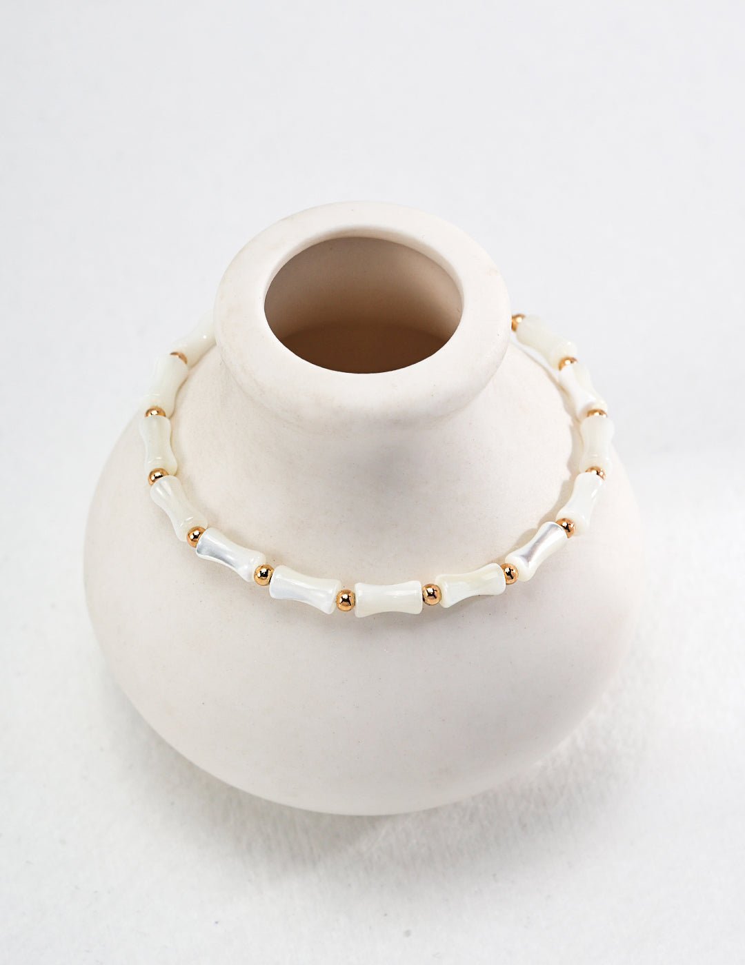 Bamboo necklace featuring conch shell with gold-plated silver by ronny